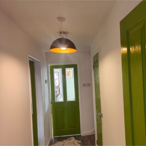Hallway with freshly painted doors and window frames by G. Hull
