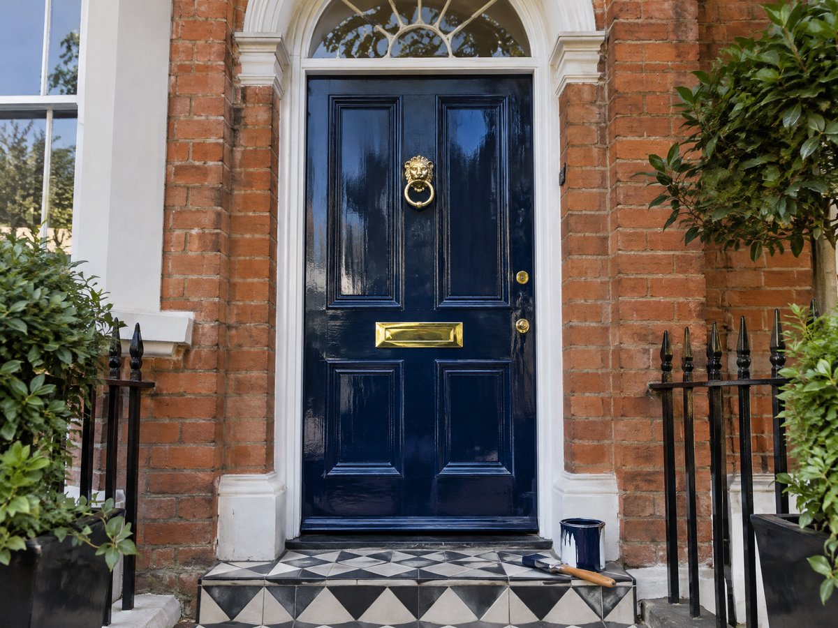 Illustrative image of a freshly painted navy front door on a period house